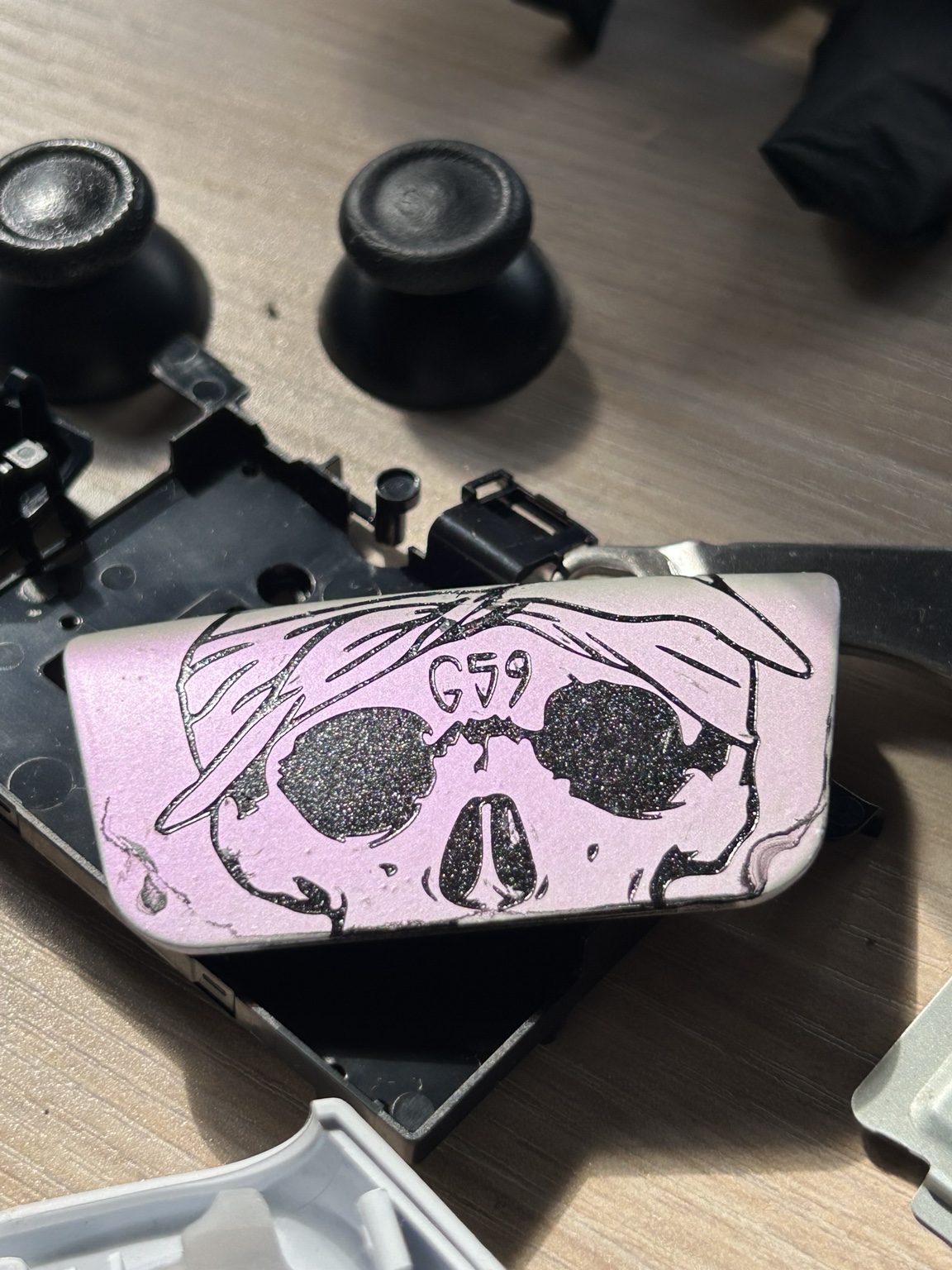 Pink custom stencil artwork on a controller touchpad